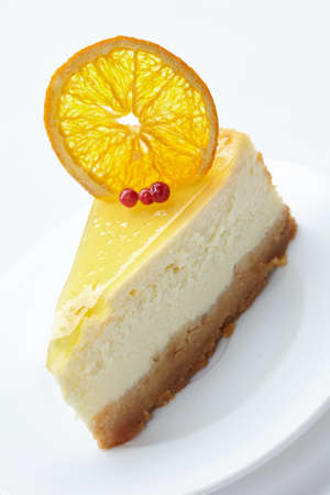 cheesecake with orange on white plateの写真素材