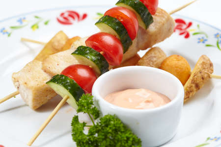 chicken kebab with sauce and vegetablesの写真素材