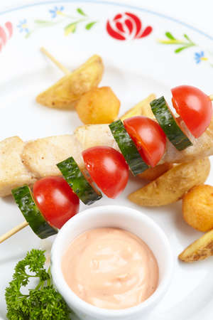 chicken kebab with sauce and vegetablesの写真素材