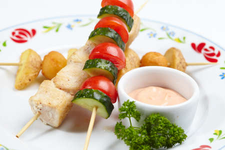 chicken kebab with sauce and vegetablesの写真素材