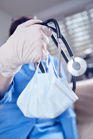 Male Doctor with stethoscope and maskの写真素材