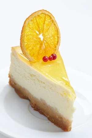 cheesecake with orange on white plateの写真素材