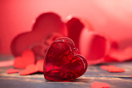 Valentine day greeting card. Hearts on the wooden backgroundの写真素材