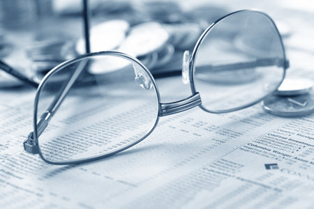 glasses and coins on the tableの写真素材