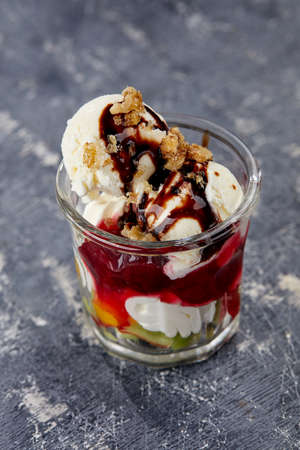 ice cream with fresh fruits and syrupの写真素材