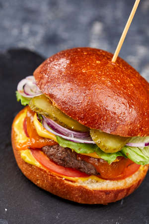 tasty burger with beef cutlet and vegetablesの写真素材