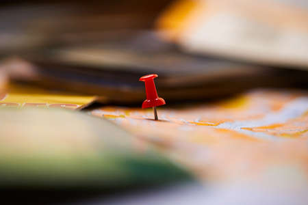 pins marking travel itinerary points on map and passportの写真素材