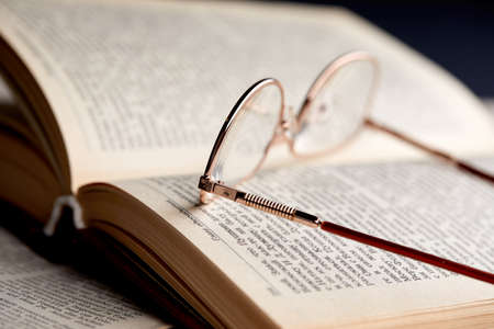 glasses on the book pagesの写真素材