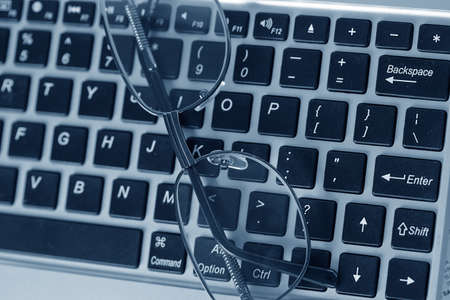 glasses on the keyboardの写真素材