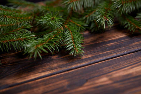 Christmas tree branches on the wooden backgroundの写真素材