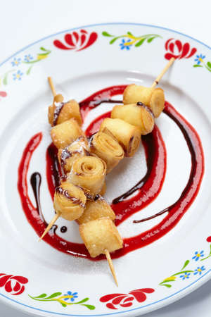 fried sweet rolls with berry sauce