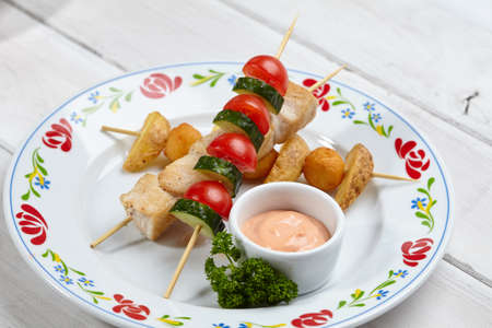 chicken kebab with baked potatoesの写真素材