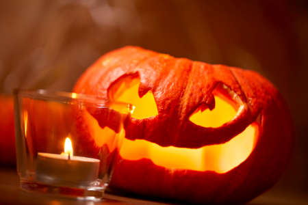 Halloween pumpkin and tea candleの写真素材