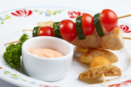 chicken kebab with baked potatoesの写真素材