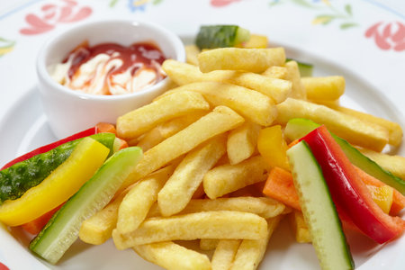 French fries with sauce and vegetablesの写真素材
