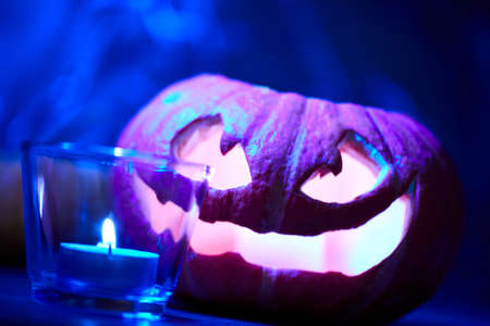Halloween pumpkin and tea candleの写真素材
