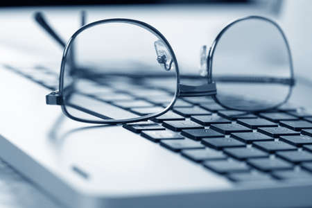 glasses on the keyboardの写真素材