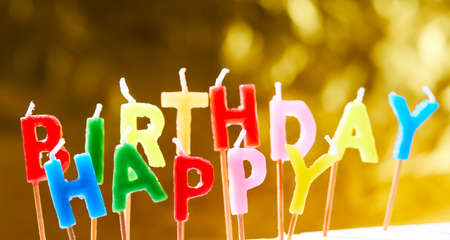 birthday candles on the yellow backgroundの写真素材