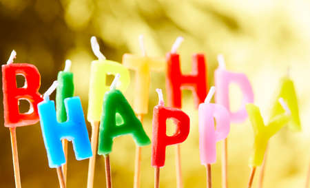 birthday candles on the yellow backgroundの写真素材