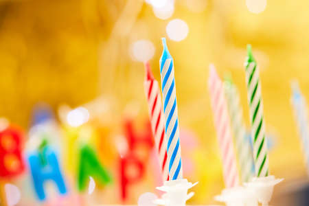 birthday candles on the yellow backgroundの写真素材