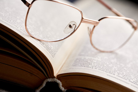 glasses on the book pagesの写真素材