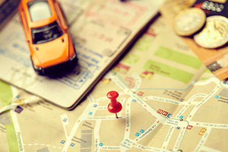 travel concept - small toy car on the map