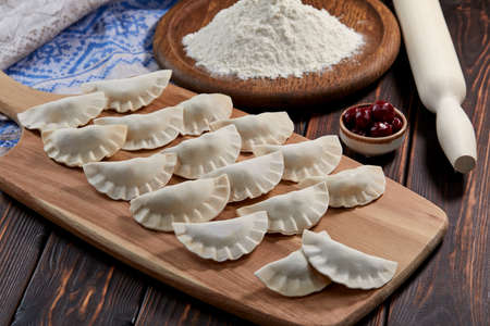raw dumpling with cherry on the wooden boardの写真素材