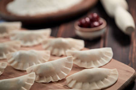 raw dumpling with cherry on the wooden boardの写真素材
