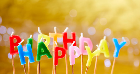 birthday candles on the yellow backgroundの写真素材