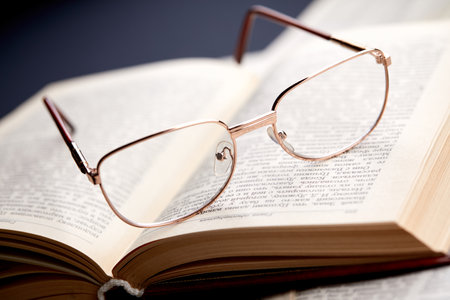 glasses on the book pagesの写真素材