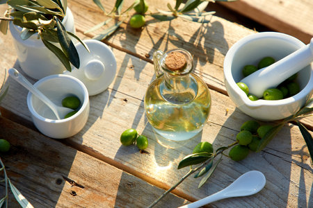 Olive oil and berries are on the wooden tableの写真素材