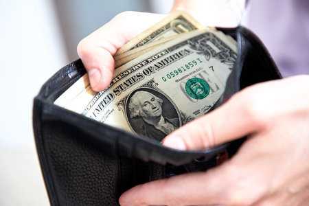 man hand putting money closeupの写真素材