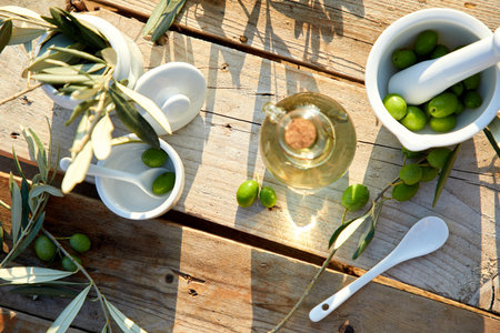 olive oil and green olive on the wooden backgroundの写真素材