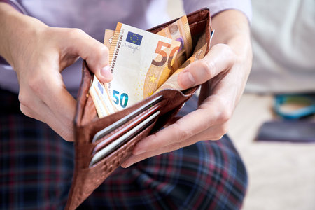 man hand putting money closeupの写真素材