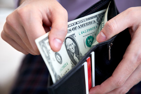man hand putting money closeupの写真素材