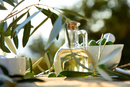 olive oil and green olive on the wooden backgroundの写真素材