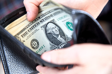 man hand putting money closeupの写真素材