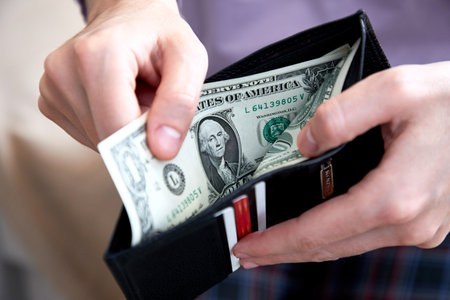 man hand putting money closeupの写真素材