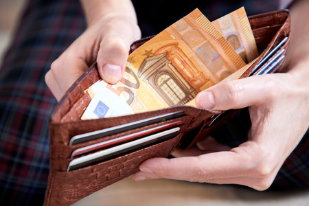 man hand putting money closeupの写真素材