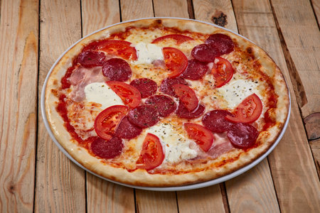 tasty pizza on the wooden backgroundの写真素材