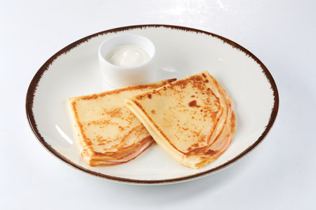 pancakes with sour cream on white plateの写真素材