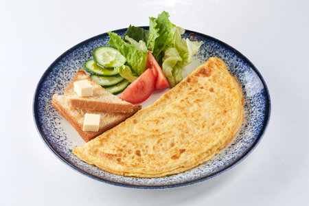 omelet with toasts and vegetablesの写真素材