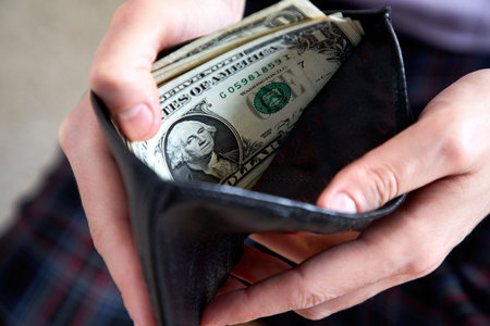 man hand putting money closeupの写真素材