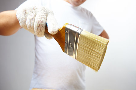 men with brush in glovesの写真素材