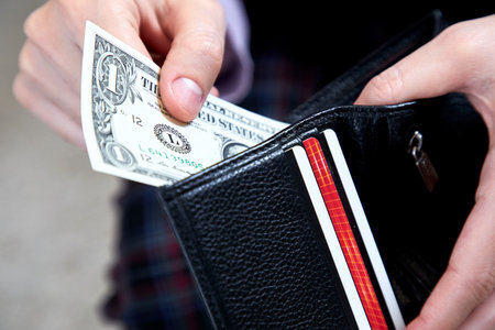 man hand putting money closeupの写真素材