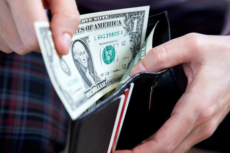 man hand putting money closeupの写真素材