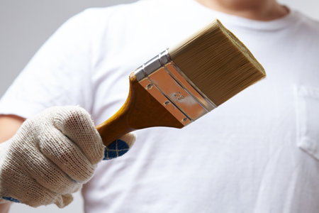 men with brush in glovesの写真素材