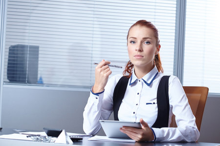 Young businesswoman sitting at workplaceの写真素材
