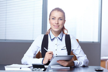 Young businesswoman sitting at workplaceの写真素材