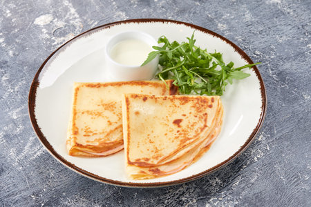 pancakes with sour cream on white plateの写真素材